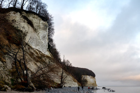 The Chalk cliffs on the Baltic Sea on the island of RÃ¼gen, Mecklenburg-Western Pomerania, Germany, Europe. With people walking along the beachの写真素材