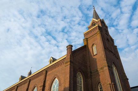 Church of St. Agnes in Egmond aan Zee in the Netherlands with sky and cloudsの写真素材