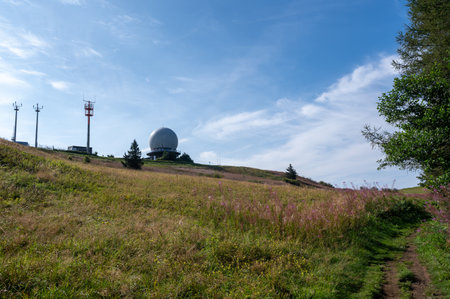 Radar dome and antennas on the summit of the Wasserkuppe in the High Rhoen Mountains in Germany on a beautiful summer day with a blue skyの写真素材