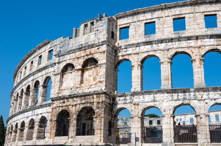 Part of the Pula Arena, the sixth largest amphitheater of its kind, with a blue sky in Croatia, Europeの写真素材