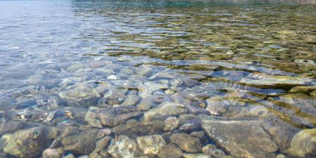 View from above of many stones in the clear water on the sea coastの写真素材