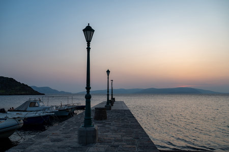 Lanterns on a pier with boats, by the sea after sunset, on the coast of Croatia, Europeの写真素材
