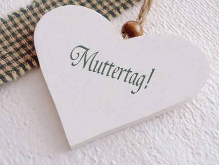Wooden heart for mothers day with german textの写真素材