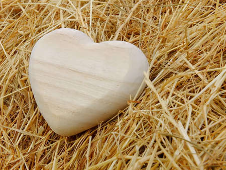 Image of a wooden heart with strawの写真素材