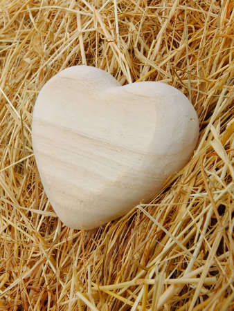 Image of a wooden heart with strawの写真素材