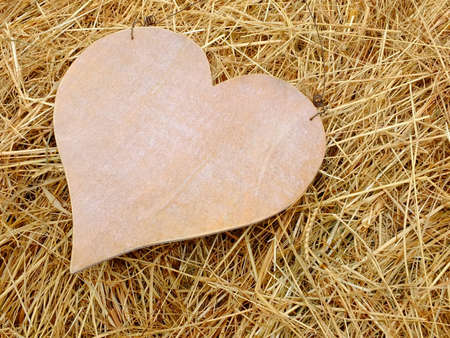 Image of a wooden heart with strawの写真素材