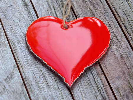 Red heart on wooden background
