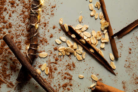 A composition with licorice sticks, cinnamon sticks and cinnamon powder. Festive food. Chill and cozy vibesの写真素材