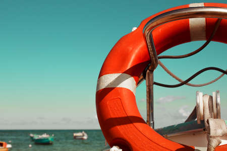 Lifebuoy on the deck of a boat against the background of the seaの写真素材