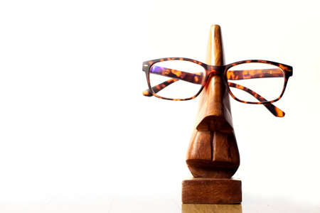 Wooden mannequin with glasses on a white background. High quality photoの写真素材
