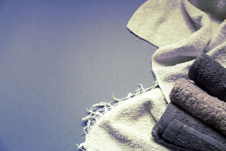 Folded towels on grey background, top view. Space for textの写真素材