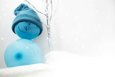 Blue toy snowman on a white background. Christmas and New Year concept.の写真素材
