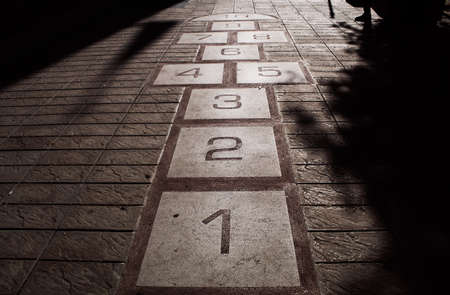 Numbers on the pavement in the shade of a tree. High quality photoの写真素材