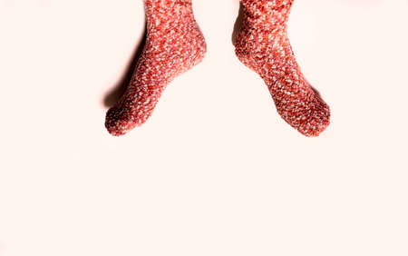 Female feet in red socks on a white background. Top view.の写真素材