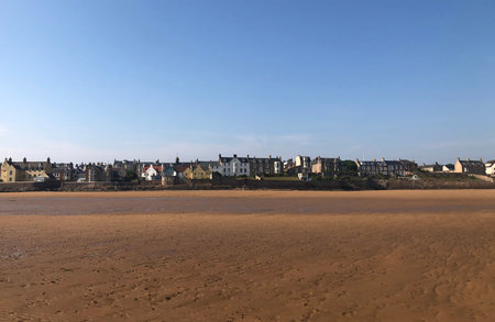 View across the beach of the seawall of the town of Elie in Fife, Scotland.の写真素材