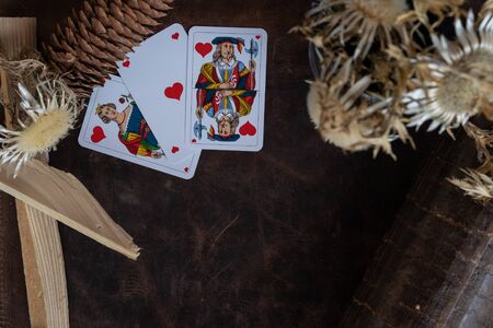 Valentine's day, playing cards on leather background with queen of Heart, Jack and highest Trump....