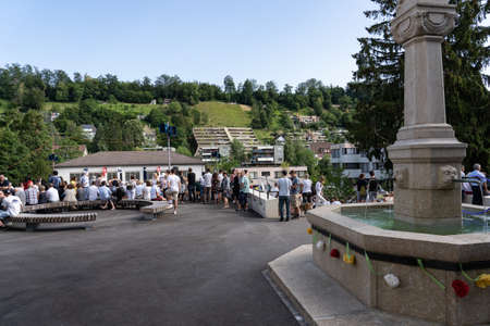 People take place near the decorated fountain and the new designed place from stapferschulhaus to listen to the speech and the choir of school children at Morgenfeier on the 4th of july at Jugendfest Brugg 2019.のeditorial素材