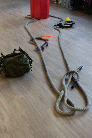 Gym equipment for boot camp and work out with kettle bell, rope, sandbag in gym hall on the floor....