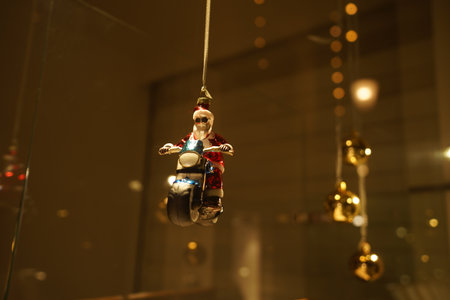 Santa Clause bauble on motorcycle. Retro and vintage decoration in illuminated showcase in dark evening. Christmas window shopping in side street of Bahnhofstrasse Zurich. Zurich, December 19, 2020.の写真素材