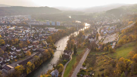 Drone view of city Brugg south-west and Umiken with Aare river, residential districts, bridge and old mill, famous train viaduct in canton Aargau in Switzerland. Town situated on feet of Tafeljura.の写真素材
