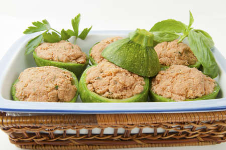 round pumpkin stuffed with bread and tuna in a baking dishesの写真素材