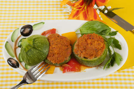 round pumpkin stuffed with bread and tuna in a baking dishesの写真素材