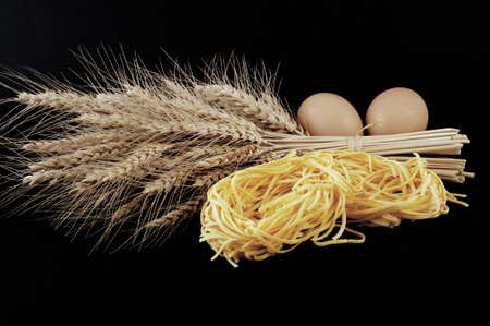 pasta with various types of grain deck eggs on blackの写真素材