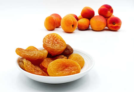 Dried apricots in a bowl isolated on white. Selective focusの写真素材