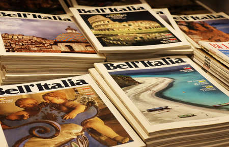 A stack of Italian magazines with landscape, art and monuments of Italy on the cover