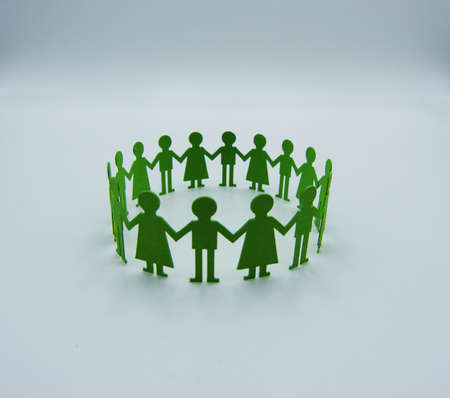 Paper children figurine hold hands isolated on white. Friendship conceptの写真素材