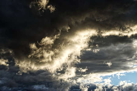 Dramatic sky with stormy clouds at sunset. Natural photo backgroundの写真素材