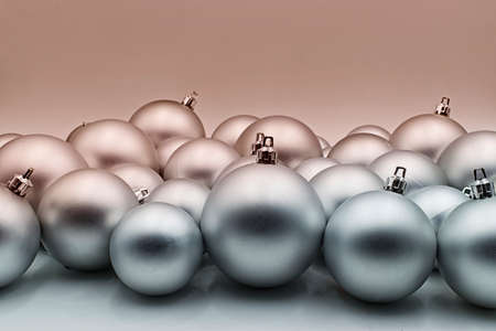 Silver christmas ball isolated on light bronze background