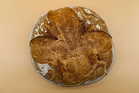 Loaf of Apulian Bread, italian pane pugliese, on yellow background
