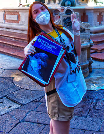 Italian WWF volunteer girl with magazines about the Covid-19 coronavirus pandemic. The worldwide coronavirus epidemicのeditorial素材