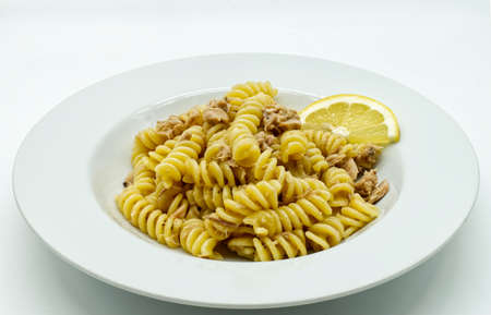 Italian Fusilli Pasta with tuna and lemon in a white dish