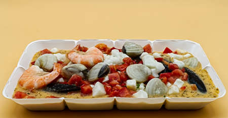 Mixed frozen seafood isolated on orange background