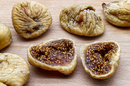 Tasty dried figs fruit on wooden table. Sweet natural dessert. Healthy eating and proper lifestyle.の写真素材