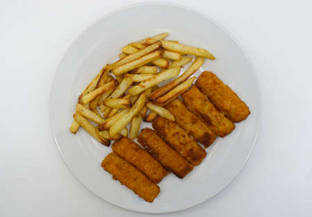 Fried fish sticks with french fries in a white dish. Top viewの写真素材