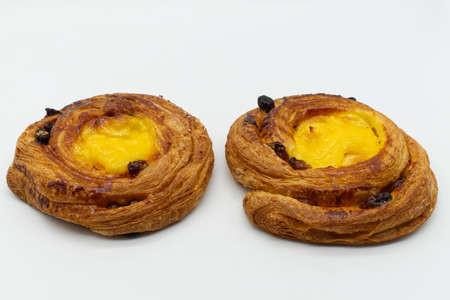 Two raisins cream brioches isolated on white background.