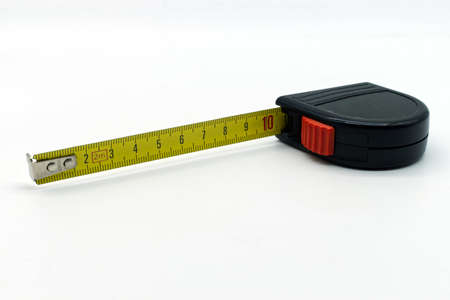 Yellow roll-up measuring meter isolated on white background.