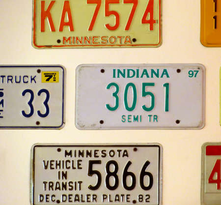 Bologna - Italy - August 1, 2014: Vintage car license plates from different USA states hanging on the wallのeditorial素材