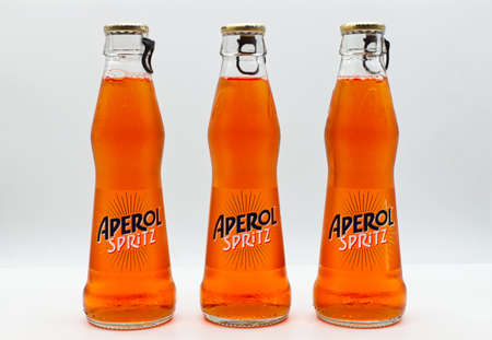 Bologna - Italy - September 18, 2021: Bottles of Italian Aperol Spritz Cocktail. Original Italian Spritz or Venetian Spritz is made mixing: Aperol, Prosecco wine, ice cubes and sparkling sodaのeditorial素材