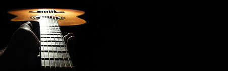 Banner with human hand holding the neck of a guitar. Web Banner with space for textの写真素材