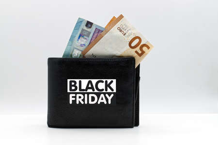 Black leather wallet with Black Friday logotype and Euro banknotes. Black Friday concept