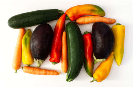 Mix of raw vegetables. Green Zucchini, Aubergine, Carrot, Pepper, isolated on white background. View...