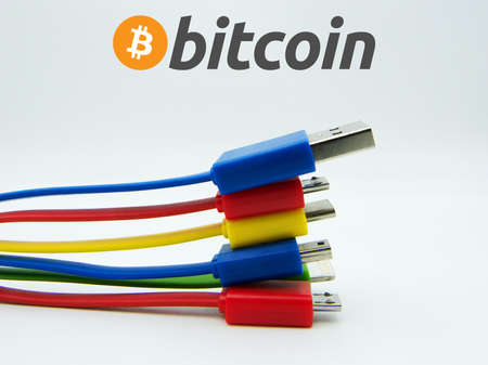 Bitcoin sign with different technological connector cables. New technological economy concept.