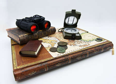 Set of items for adventure and exploration. Books, map, compass, old coin isolated on white...