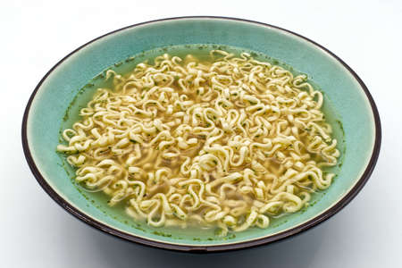 Chicken noodle cream soup in a bowl isolated on white background.