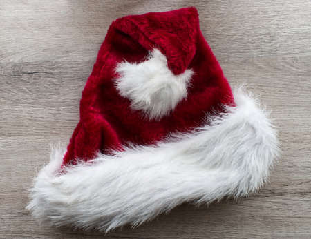 Santa Claus hat isolated on wooden background. Merry Christmas and happy new year conceptの写真素材