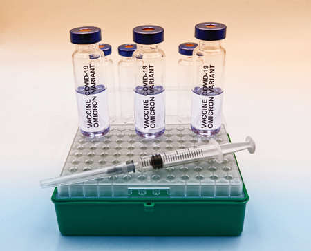 Glass vials with Covid-19 Vaccine Omicron Variant. Omicron variant concept